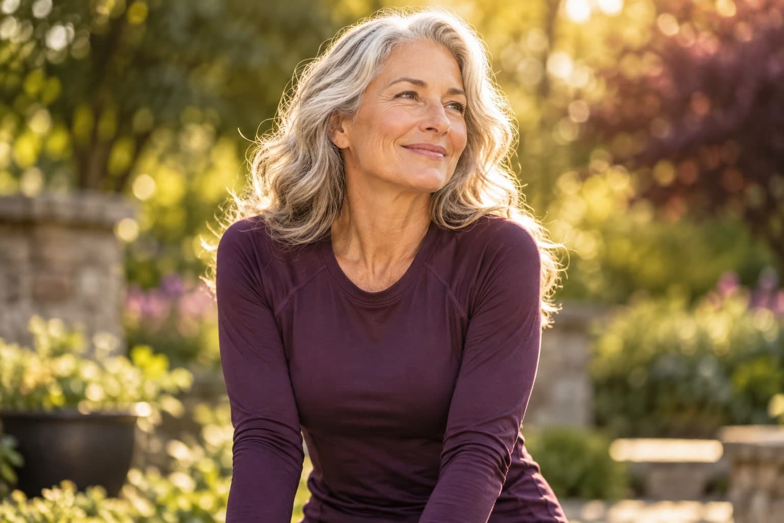 An adult woman enjoying time outdoors after exercise in athletic clothing.